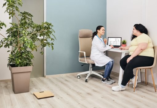 Nutritionist consultation. Dietitian plans a meal plan for a female overweight patient at a diet clinic