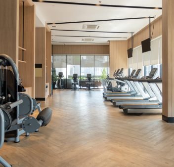 Modern fitness center with gym equipment decoration. interior design background