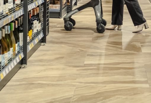 woman with a trolley makes purchases in a supermarket